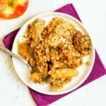 Plate with serving of apple crisp and a spoon.