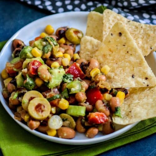 Black Eyed Pea Salad on a plate with tortilla chips.
