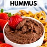 Bowl of chocolate dip with strawberries and pretzels with text overlay Dark Chocolate Hummus.