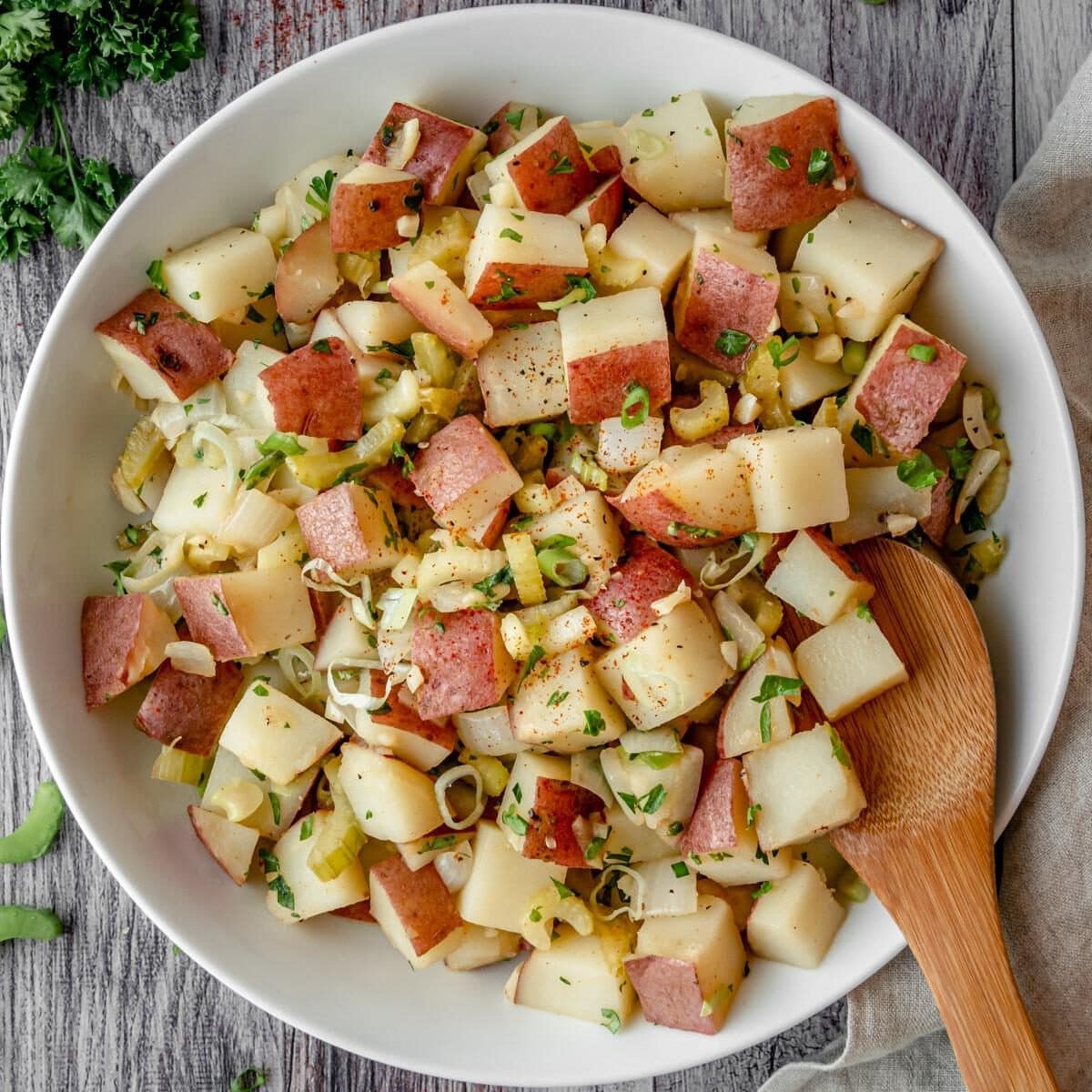 Bowl of German Potato Salad with serving spoon.