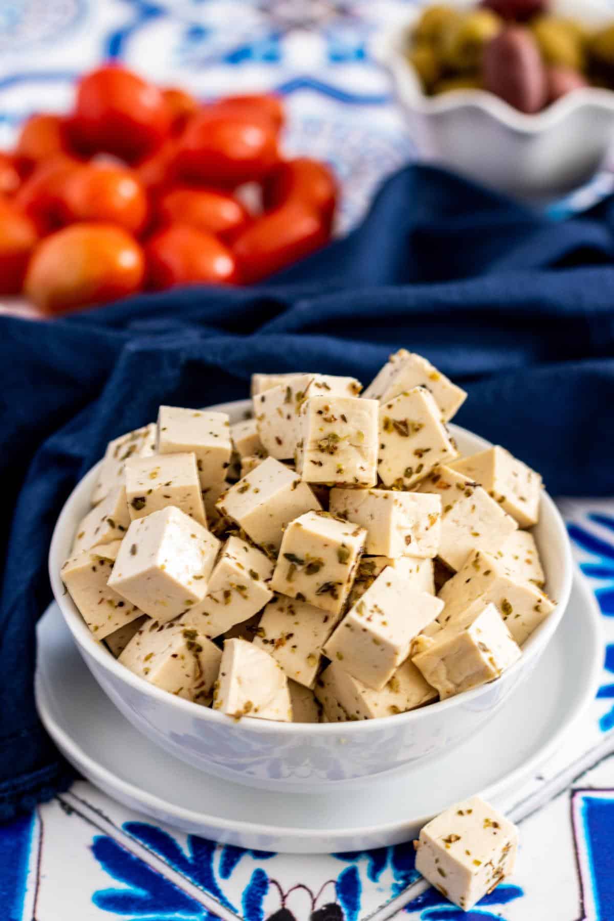 Bowls of tofu feta, grape tomatoes, and olives.