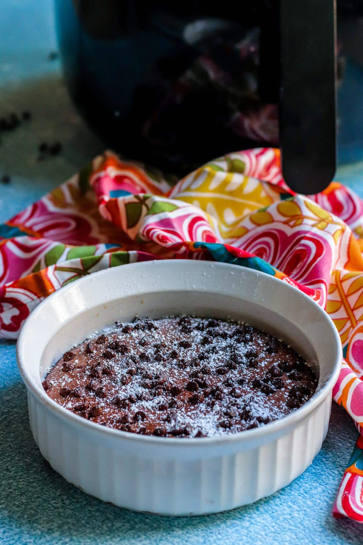 Dish of brownies in front of an air fryer.