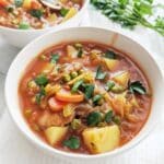 Bowls of Vegan Irish Stew garnished with parsley.