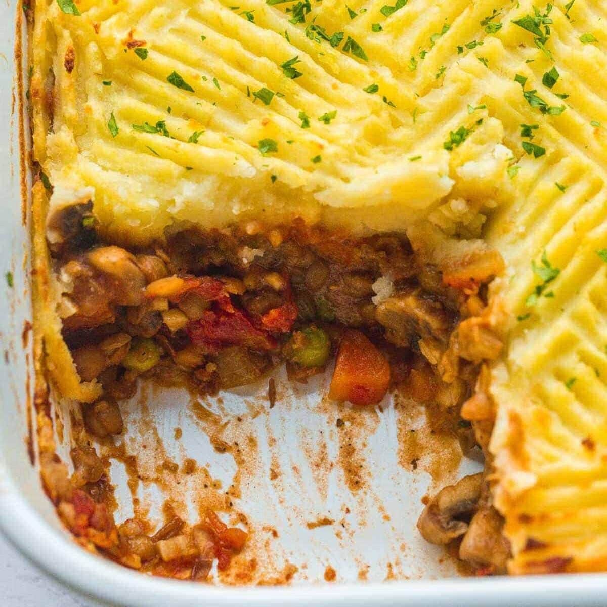 Dish of Vegan Shepherd's Pie with a serving taken out of it.