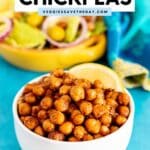Bowl of seasoned chickpeas with a lemon wedge and a bowl of salad in the background with text overlay Pan Fried Chickpeas.