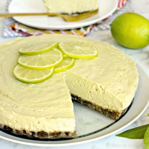 Raw Key Lime Pie on a platter with a slice taken out.