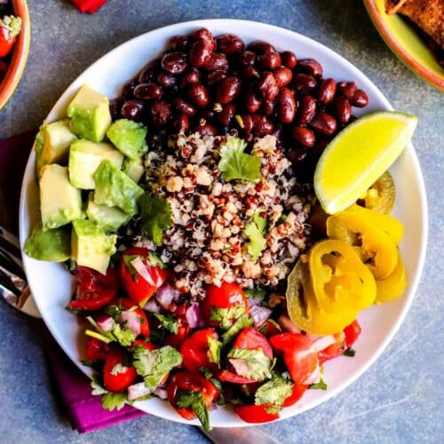 Bowl with quinoa, black beans, pickled jalapenos, fresh tomato salsa, and diced avocado.