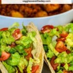 Tacos in front of a bowl of filling with text overlay Vegan Soyrizo Potato Tacos.