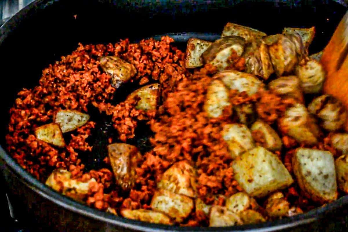 Sauteing the soyrizo and potatoes in a skillet.