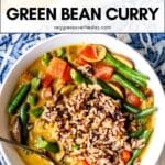 Bowl of curry and brown rice with text overlay Green Bean Curry.