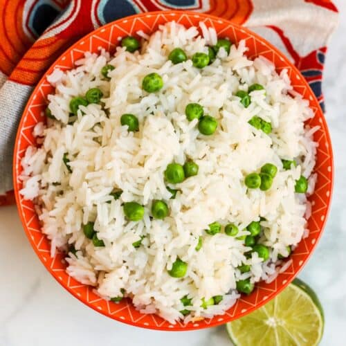 Bowl of coconut rice with a lime next to it.