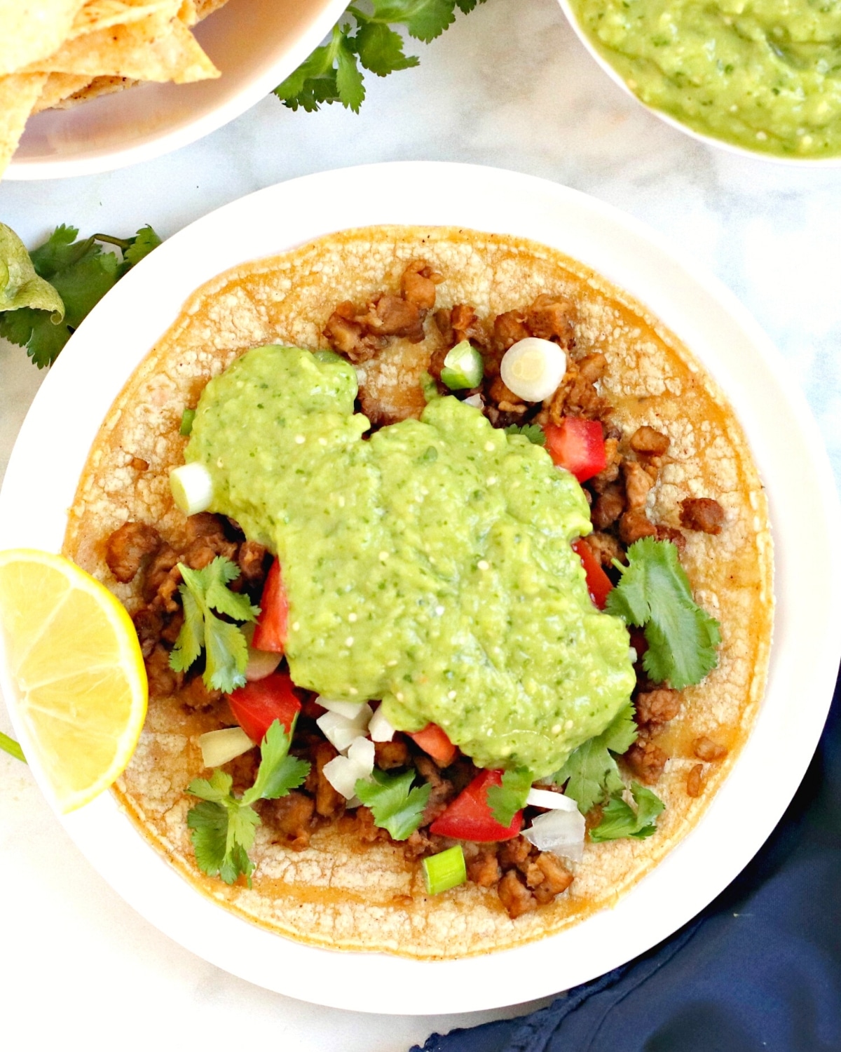 Taco topped with salsa verde.