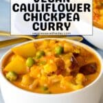 Bowl of curry with text overlay Vegan Cauliflower Chickpea Curry.