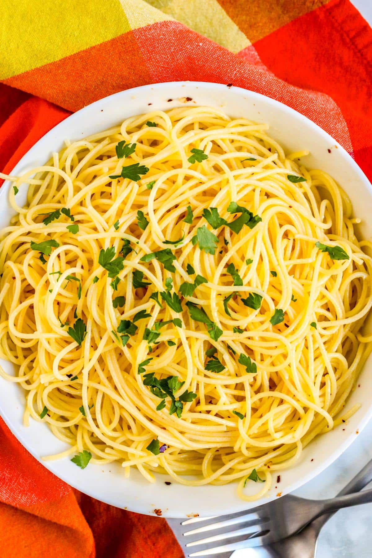 Bowl of Spaghetti with olive oil, garlic, crushed red pepper flakes, and fresh parsley.