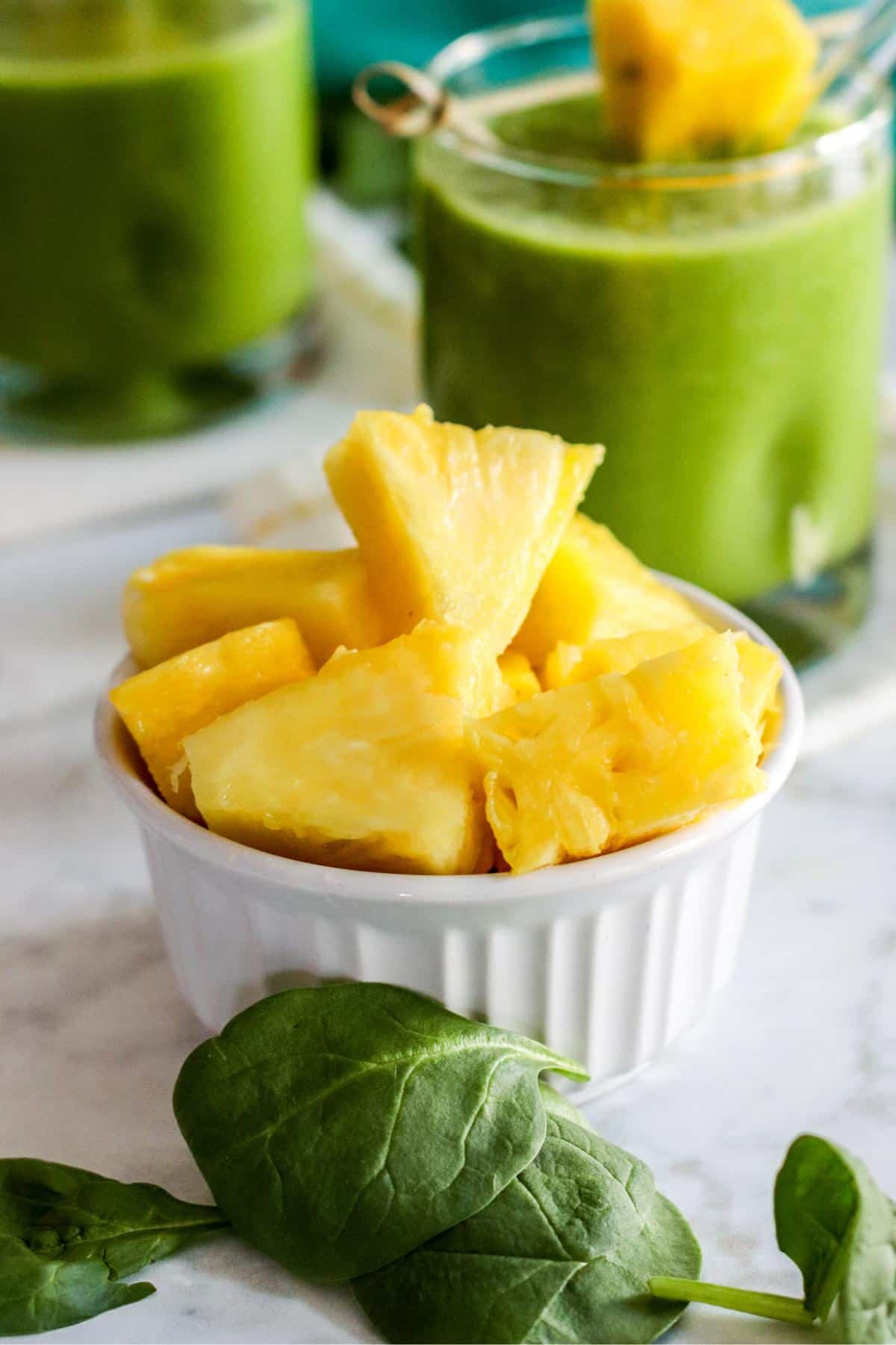 Baby spinach and a bowl of pineapple chunks.