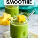 Green smoothie in a glass with text overlay Pineapple Green Smoothie.