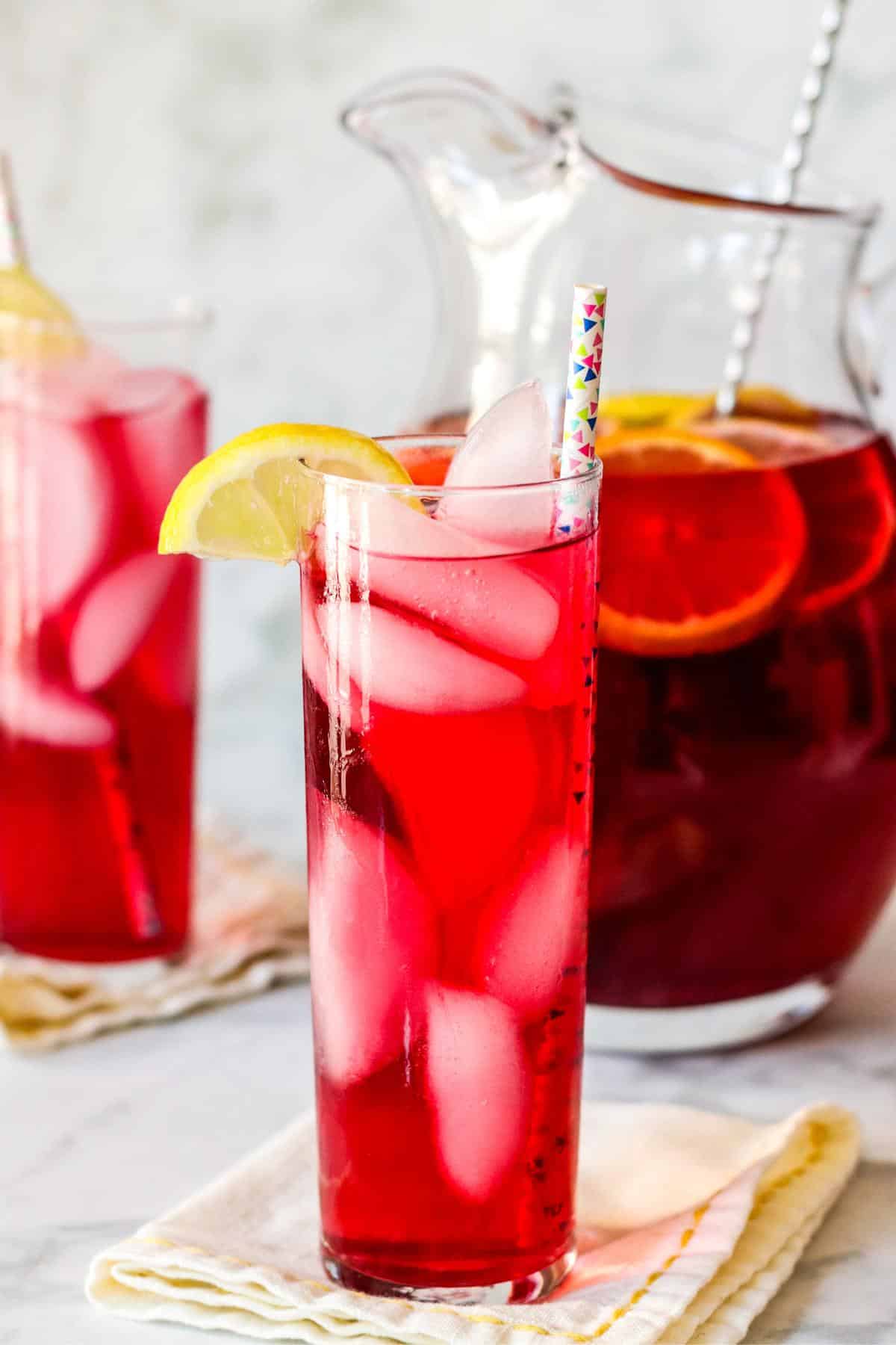 Glasses of spiked iced tea cocktails and a pitcher of tea.