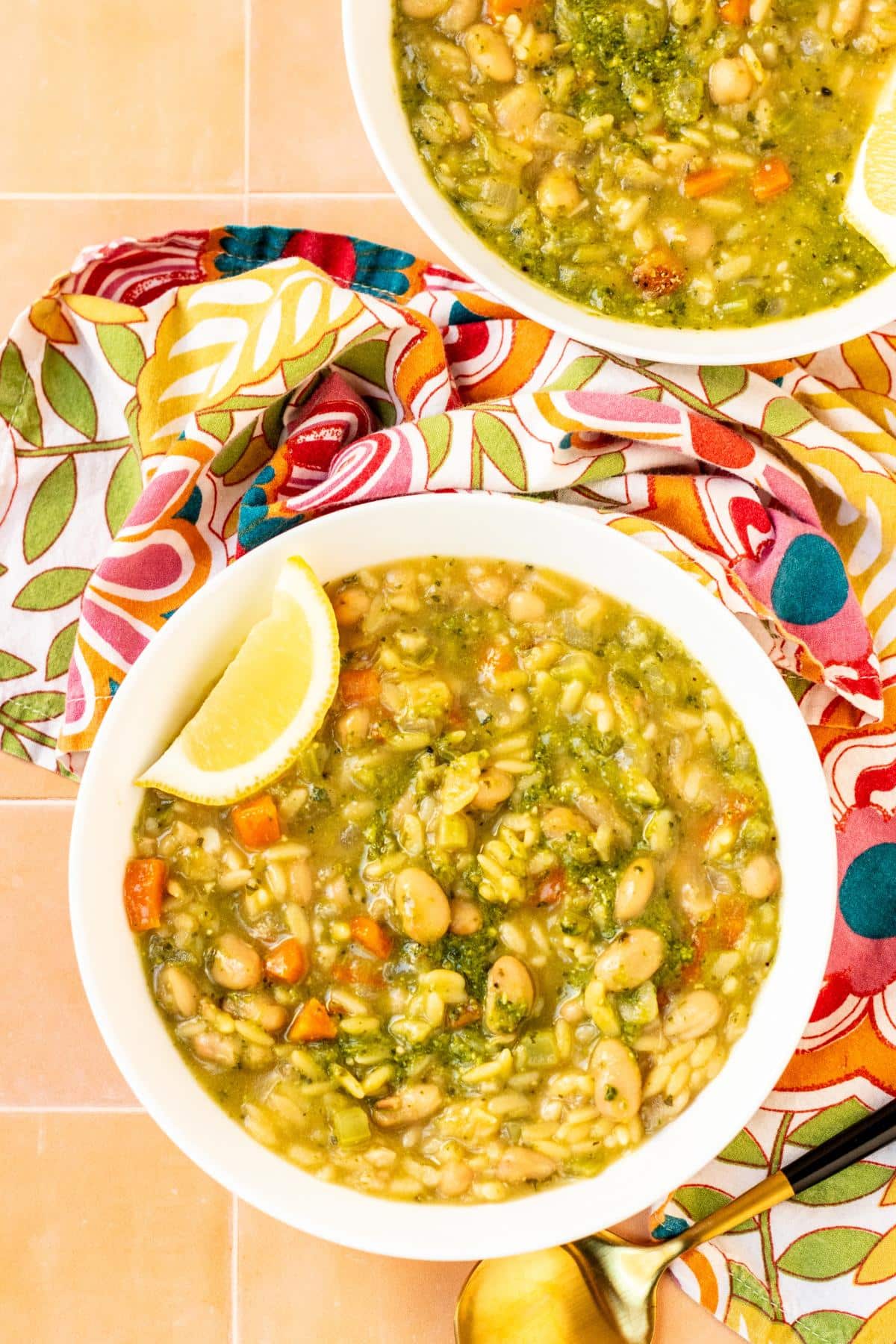 Bowls of soup garnished with lemon wedges.