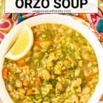 Bowl of soup with lemon wedge and text overlay Vegan Pesto Orzo Soup.