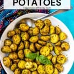 Bowl of roasted potatoes with text overlay: Vegan Pesto Potatoes.