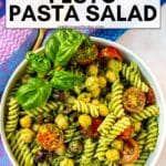 Bowl of pasta salad with text overlay: Vegan Pesto Pasta Salad.