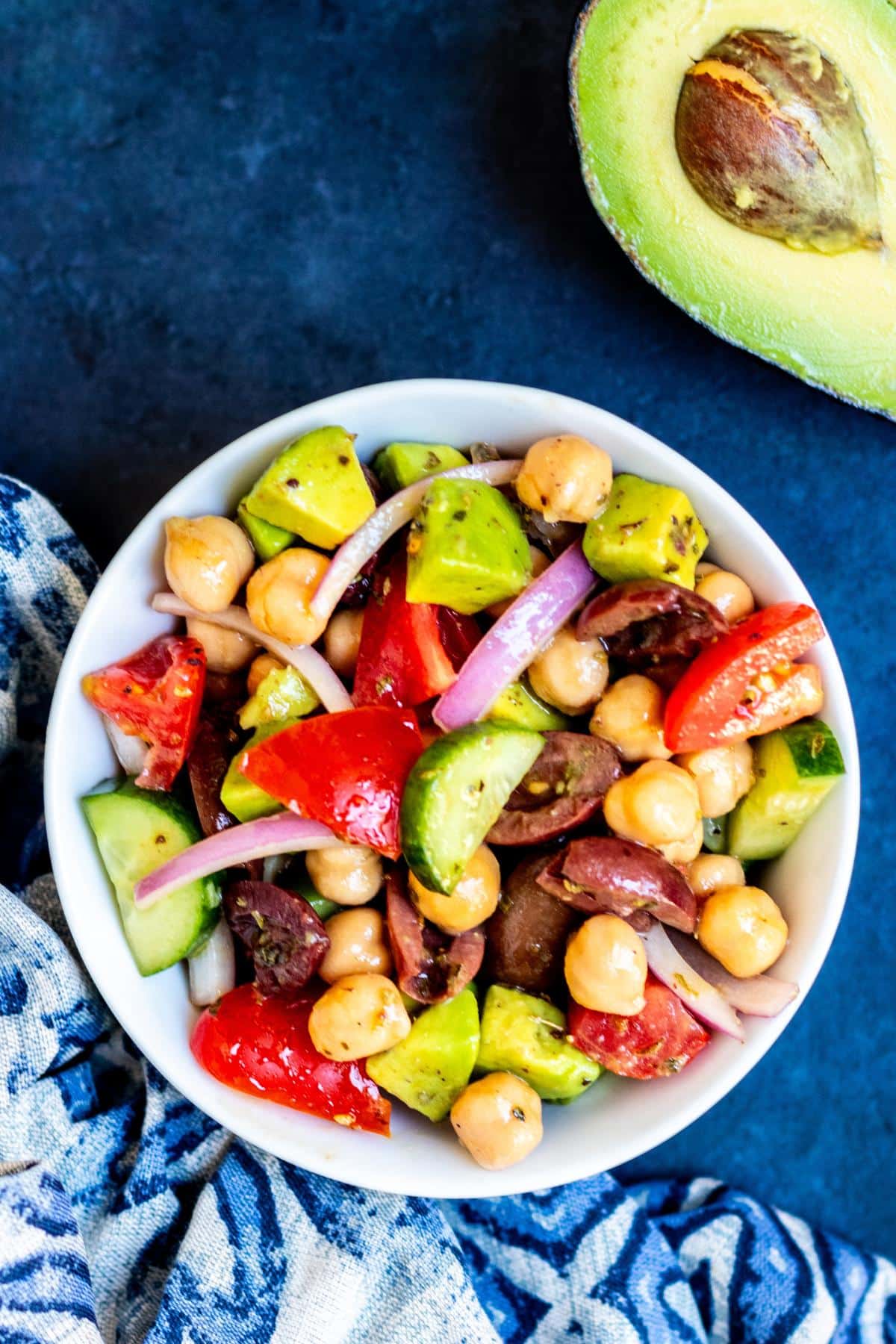 Bowl of California Greek Chickpea Salad and half an avocado.