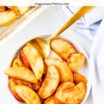 Bowl of baked sliced apples with a gold spoon and text overlay: Cinnamon-Maple Baked Apple Slices.
