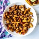 Baked tofu and bell peppers fajitas in a serving bowl.