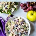 A bowl of chickpea Waldorf salad with apples, grapes, celery, walnuts, and a vegan yogurt dressing, with text overlay: Vegan Chickpea Waldorf Salad.