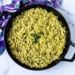 Baked pesto basmati rice in a cast iron skillet.
