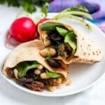 Pita pockets stuffed with sun-dried tomato cannellini bean salad and baby spinach leaves.